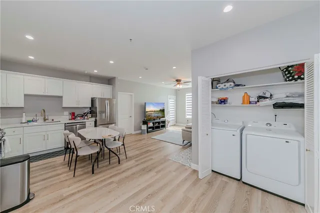 a kitchen with cabinets and wooden floor