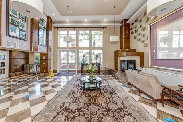 a living room with fireplace furniture and a large window