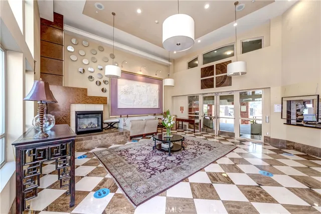 a living room with fireplace furniture and a rug