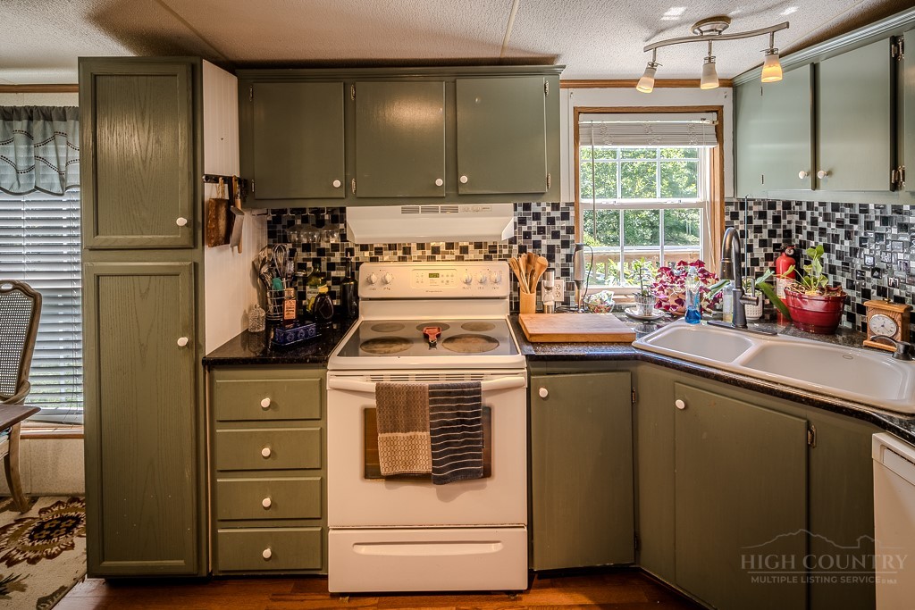 461 Reuben Wooten Road Banner Elk, NC 28604 - Photo 16 of 39 a kitchen with a stove and a refrigerator
