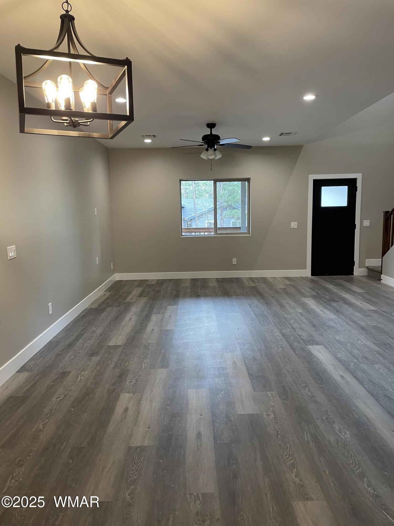 2426 Aspen Run Pinetop, AZ 85935 - Photo 11 of 44 an empty room with wooden floor and windows