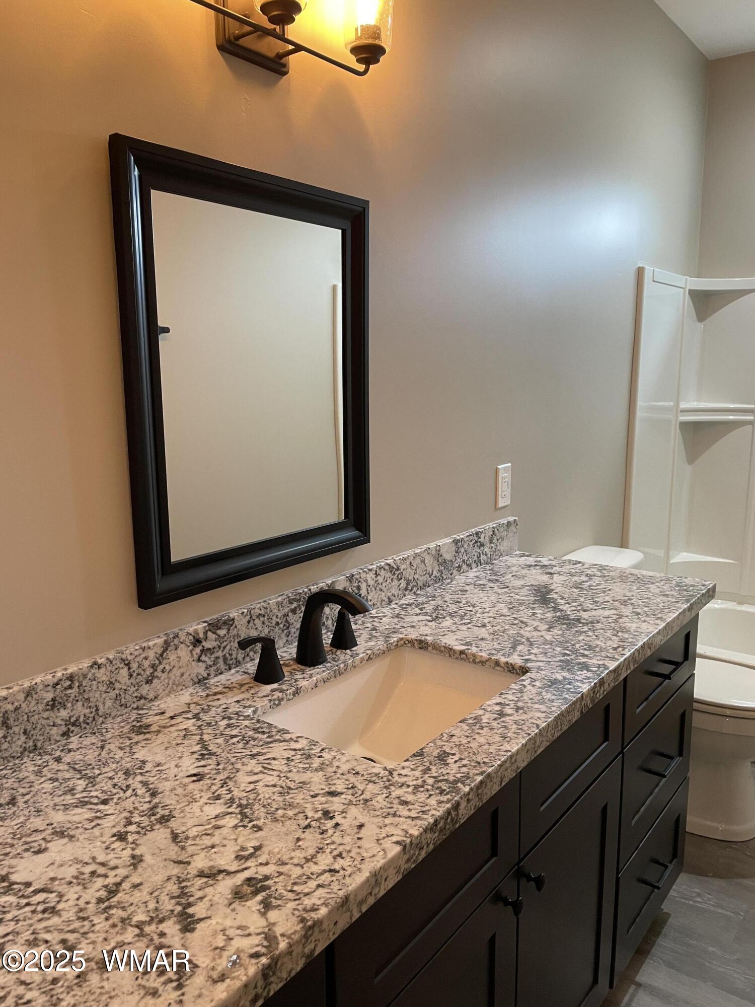 2426 Aspen Run Pinetop, AZ 85935 - Photo 16 of 44 a bathroom with a granite countertop sink and a mirror