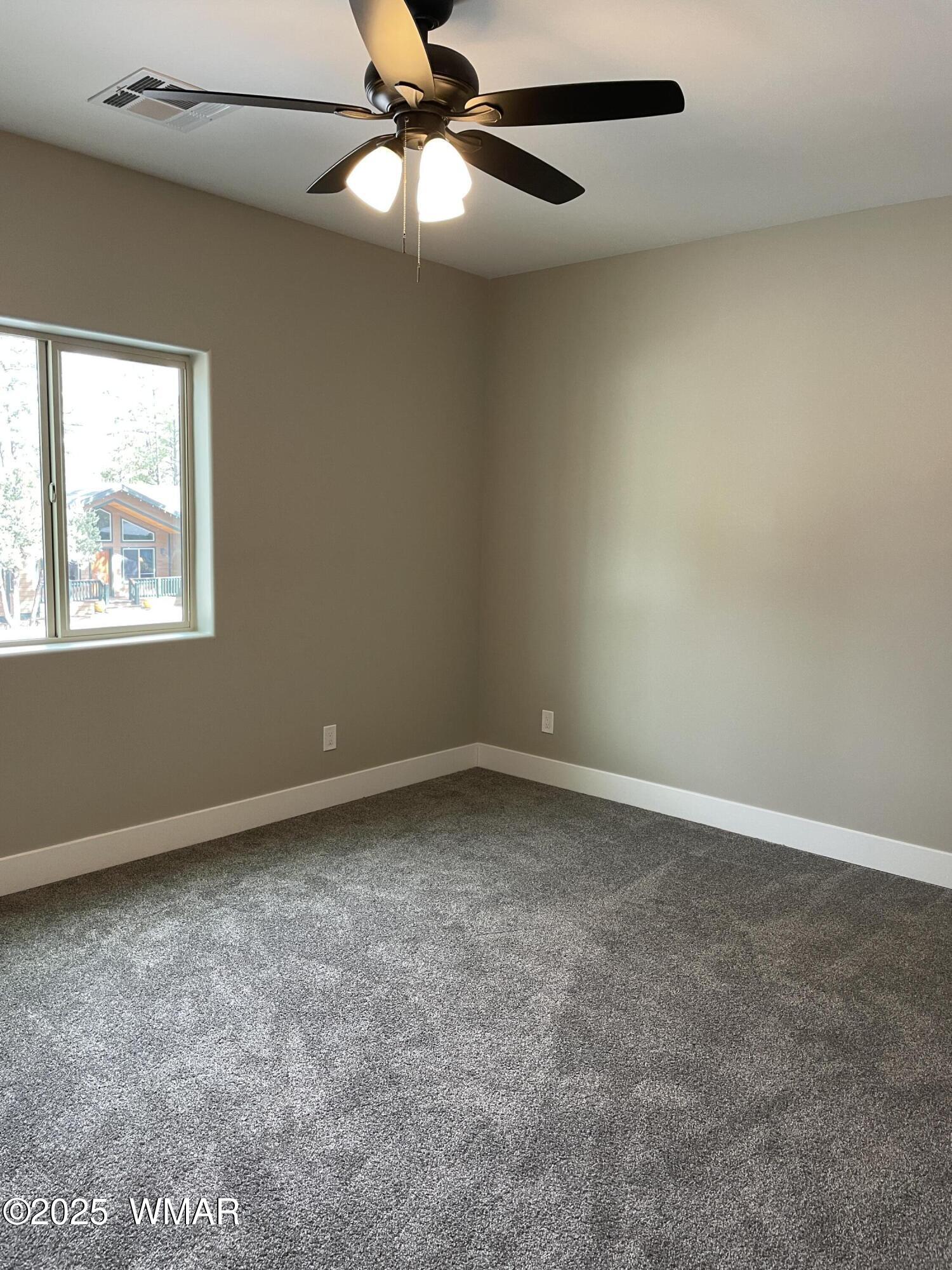 2426 Aspen Run Pinetop, AZ 85935 - Photo 20 of 44 an empty room with a window and a fan