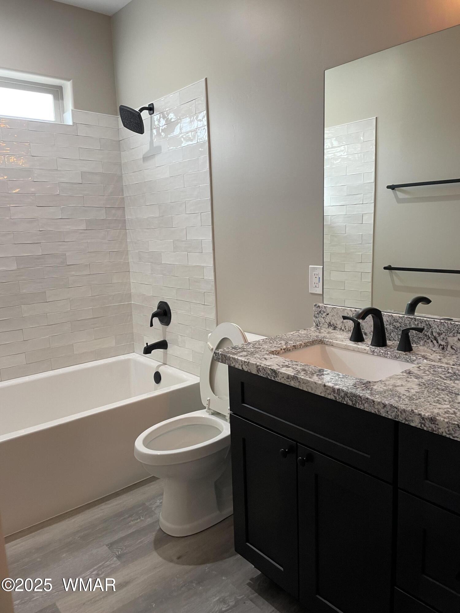 2426 Aspen Run Pinetop, AZ 85935 - Photo 21 of 44 a bathroom with a granite countertop toilet a sink and a bathtub