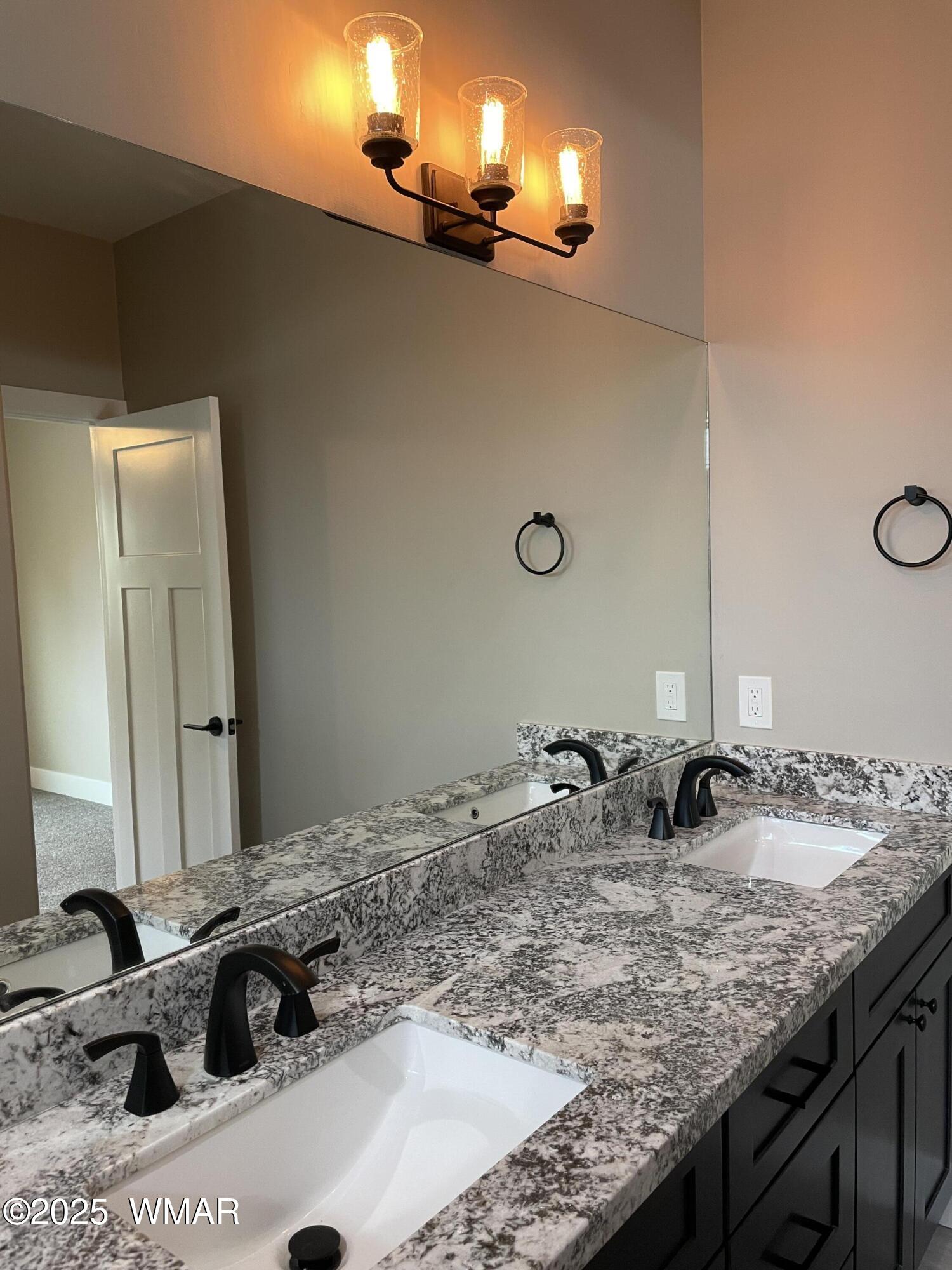 2426 Aspen Run Pinetop, AZ 85935 - Photo 23 of 44 a bathroom with a granite countertop sink and a mirror