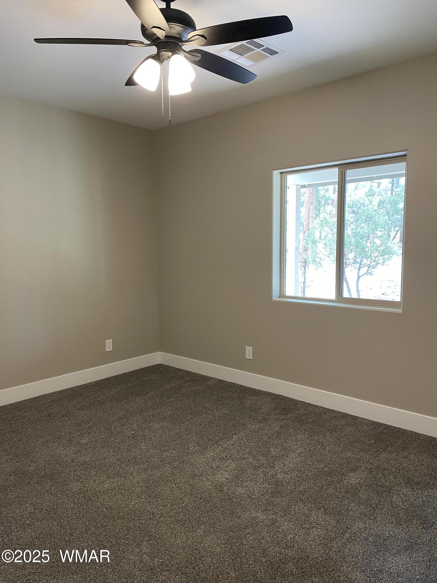 2426 Aspen Run Pinetop, AZ 85935 - Photo 25 of 44 an empty room with a window and a fan
