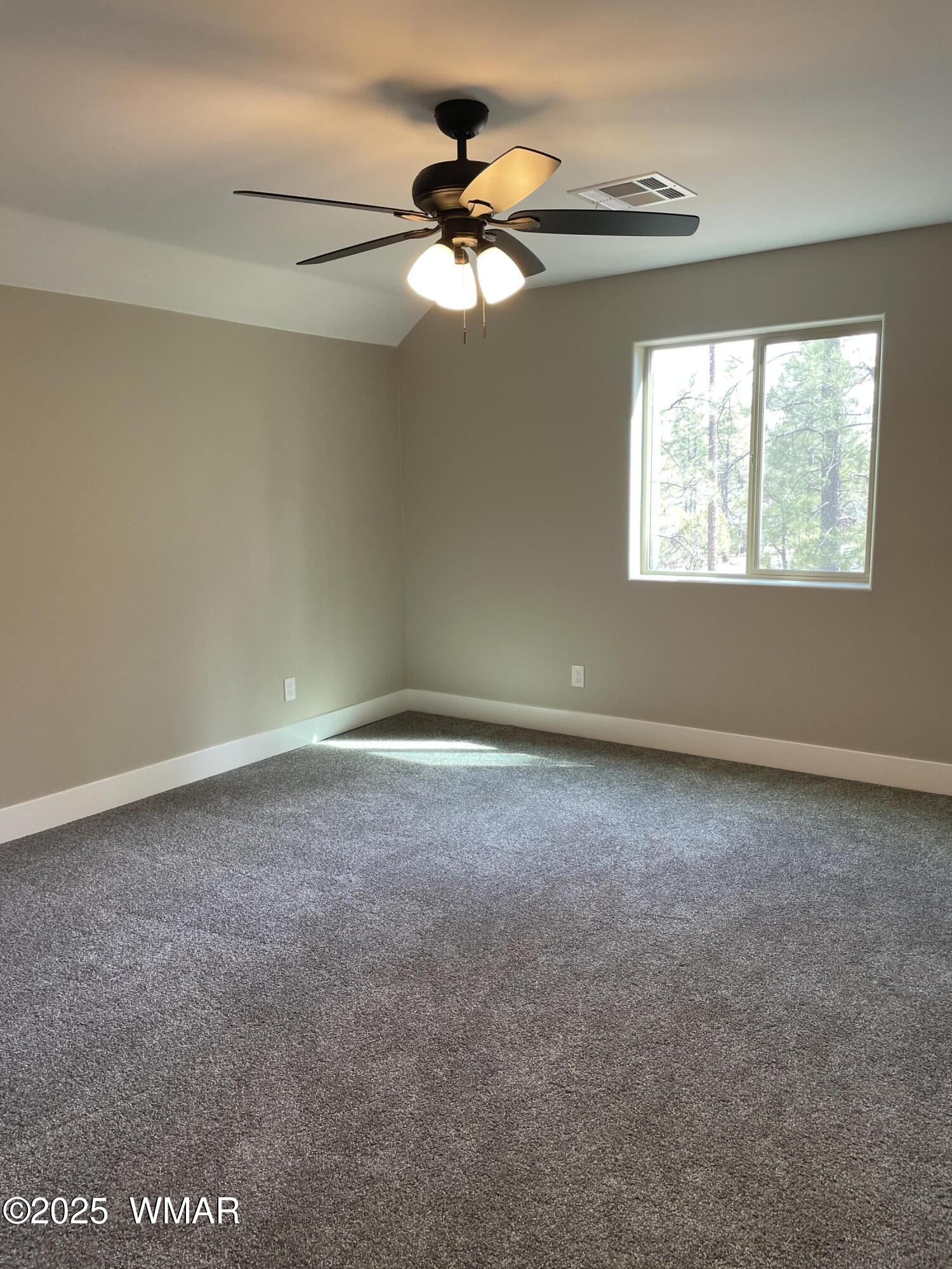 2426 Aspen Run Pinetop, AZ 85935 - Photo 27 of 44 an empty room with a window and a fan
