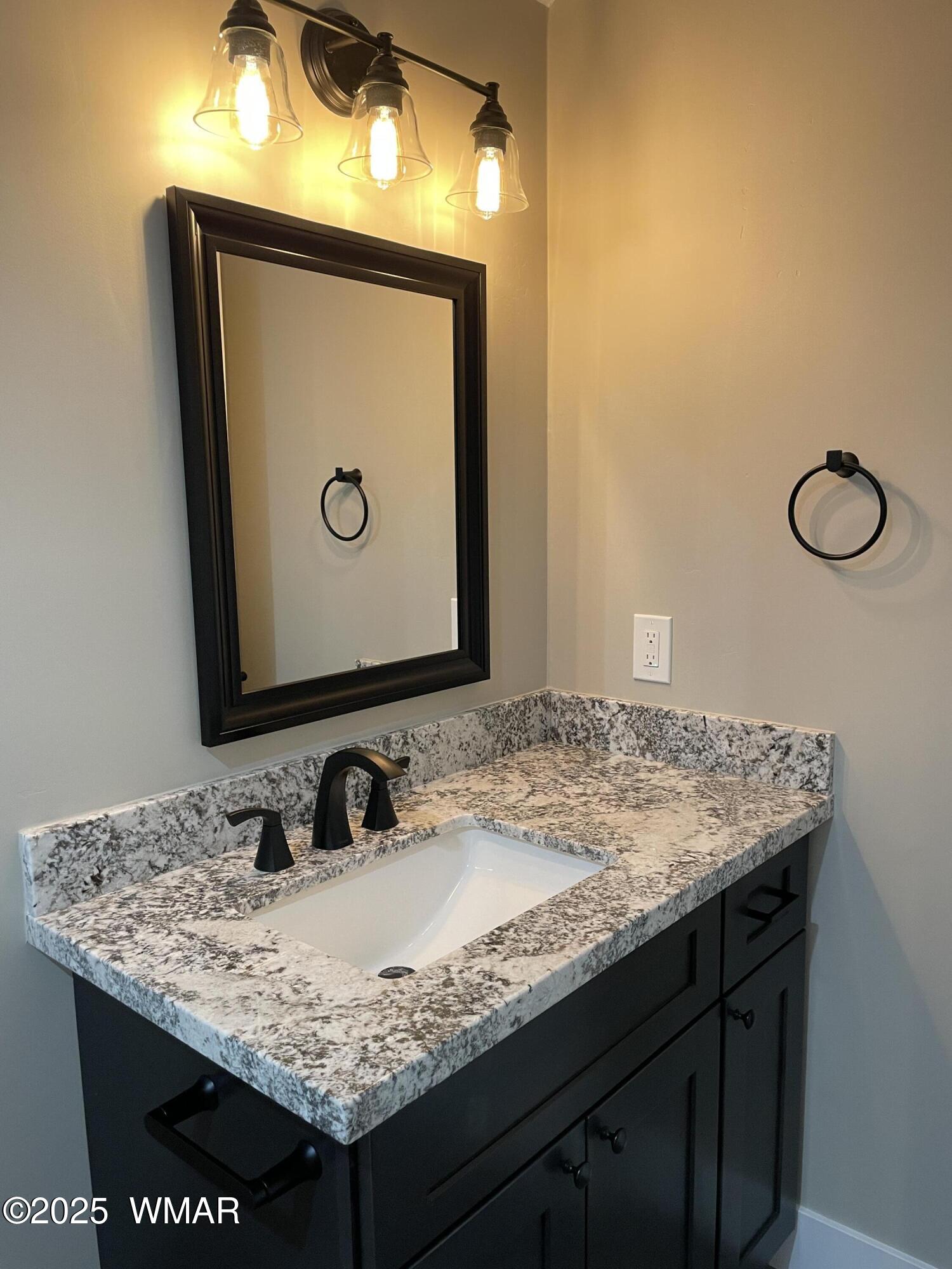 2426 Aspen Run Pinetop, AZ 85935 - Photo 29 of 44 a bathroom with a granite countertop sink and a mirror