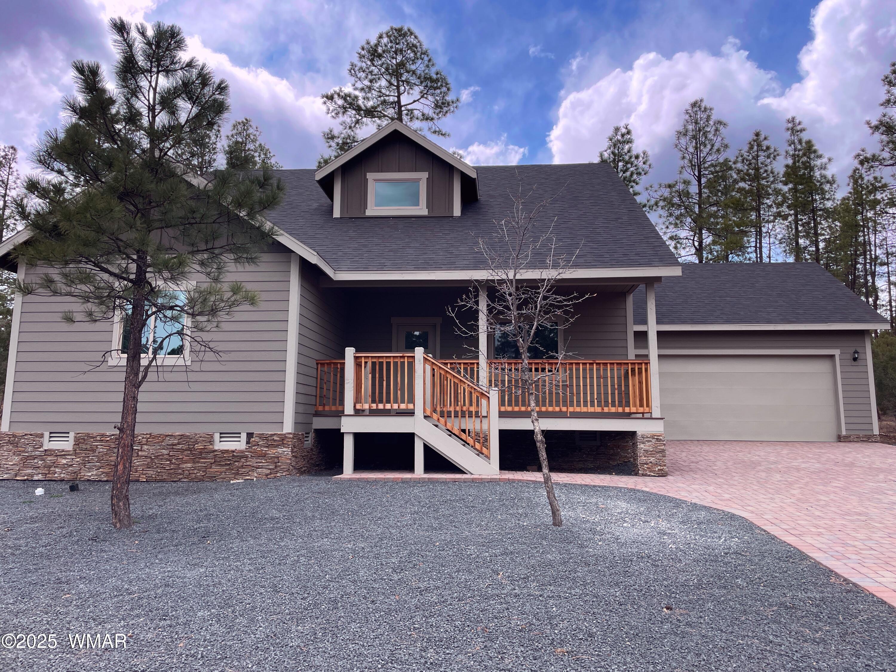 2426 Aspen Run Pinetop, AZ 85935 - Photo 4 of 44 a front view of a house with a yard and garage