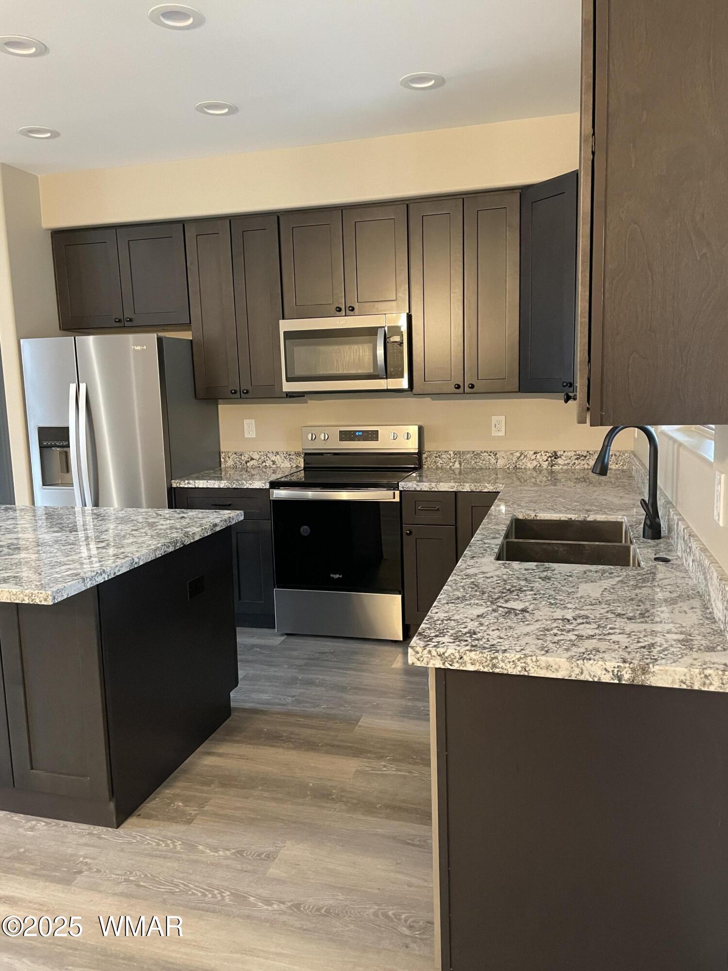2426 Aspen Run Pinetop, AZ 85935 - Photo 5 of 44 a kitchen with stainless steel appliances granite countertop a sink stove and refrigerator