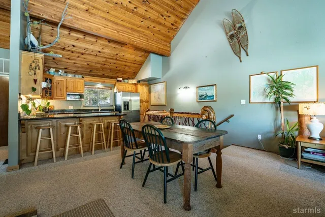 a dining room with furniture and a chandelier