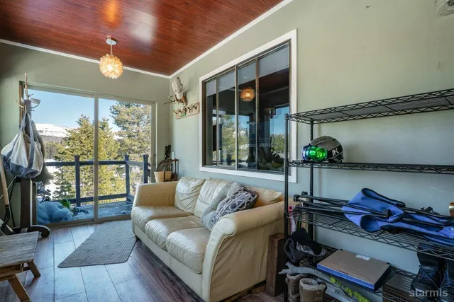 a living room with furniture and a floor to ceiling window