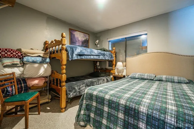 a bedroom with a bed and a chair