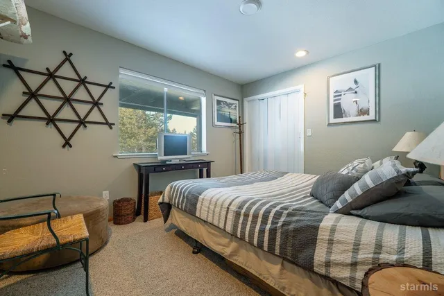 a bedroom with a bed and lamp