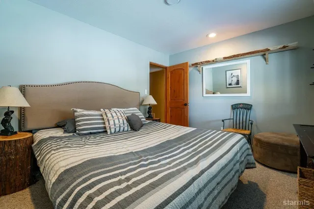 a bedroom with a bed and a painting on the wall