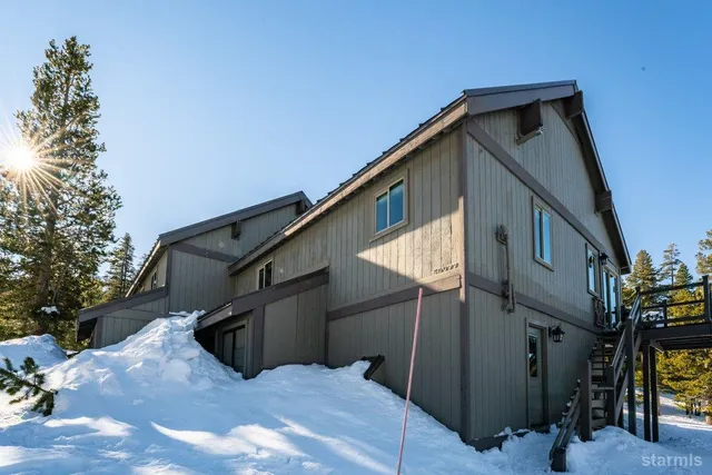 a view of a house with a snow in the background