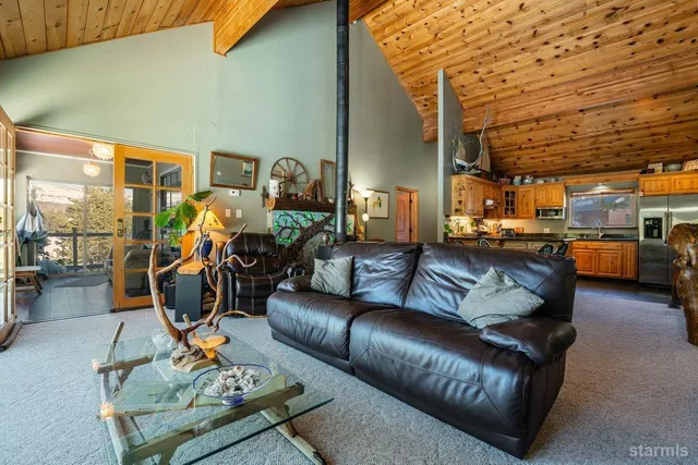 a living room with furniture washer and a view of kitchen