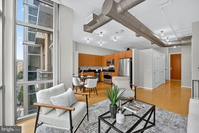 a view of a livingroom with furniture and a window