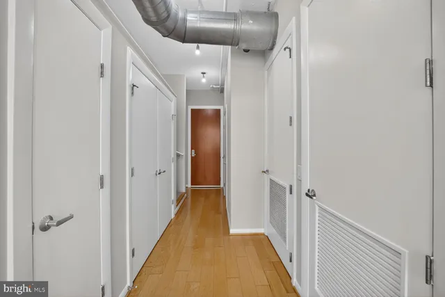 a view of a hallway with wooden floor and a hallway