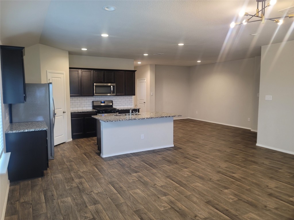 846 Autumn Flats Way Rosharon, TX 77583 - Photo 17 of 26 a large kitchen with stainless steel appliances granite countertop a stove a sink and a refrigerator