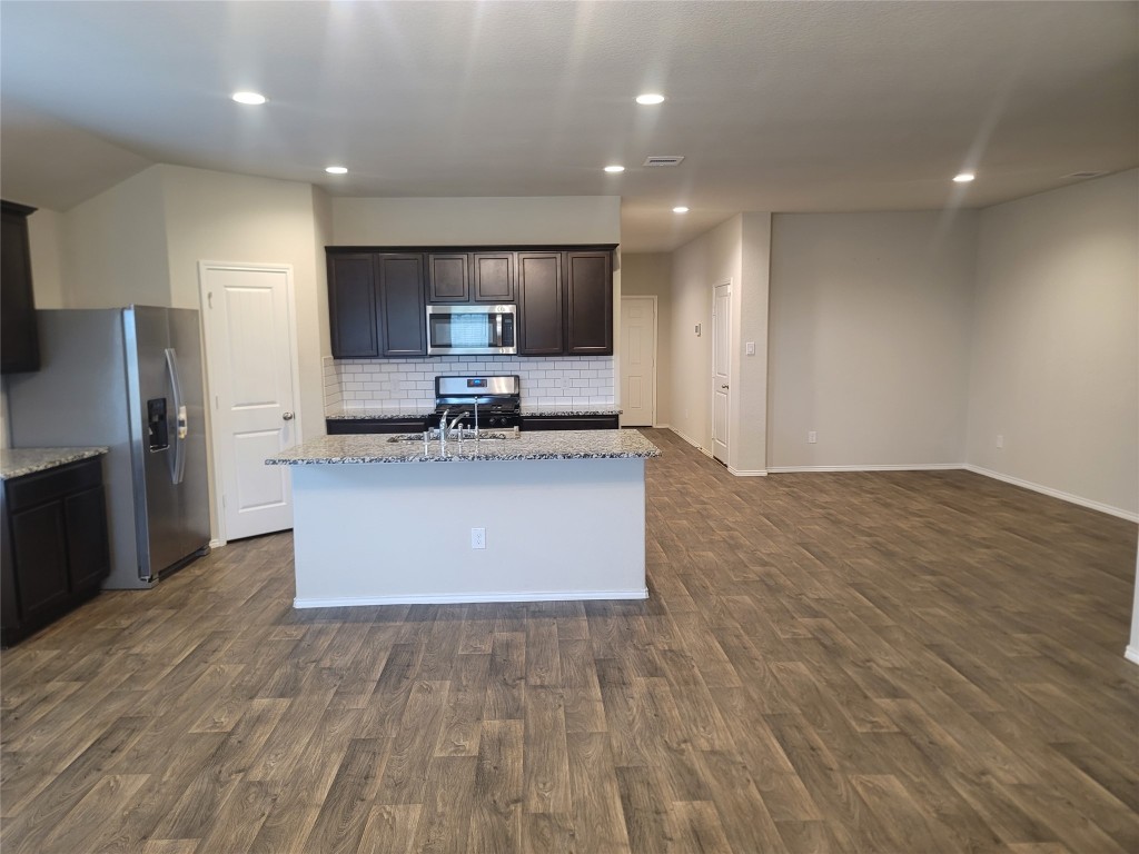 846 Autumn Flats Way Rosharon, TX 77583 - Photo 22 of 26 a large kitchen with stainless steel appliances a large counter top a stove and a refrigerator