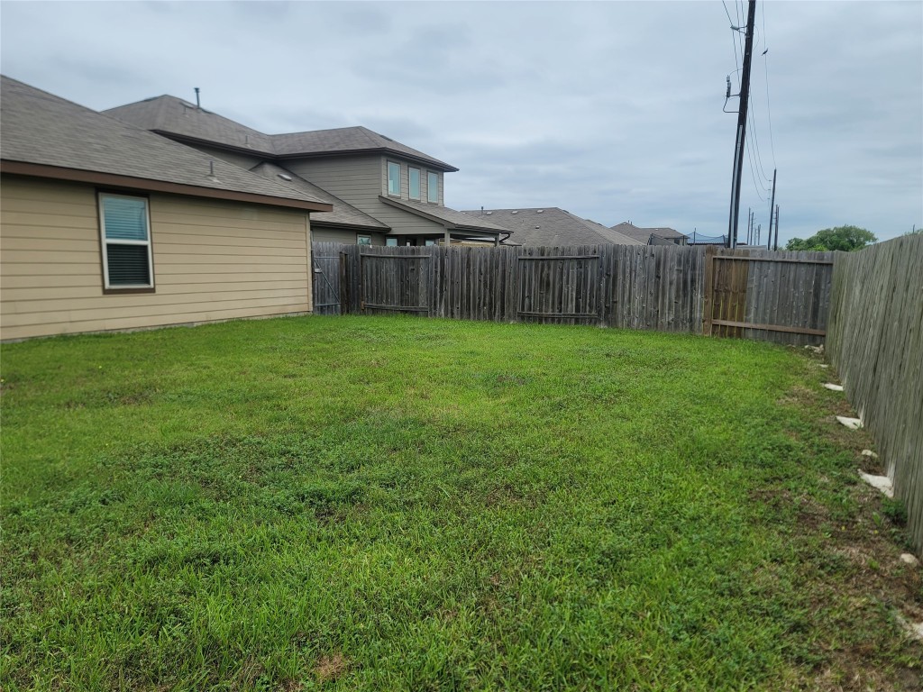 846 Autumn Flats Way Rosharon, TX 77583 - Photo 26 of 26 a view of a backyard with barn plants and wooden fence