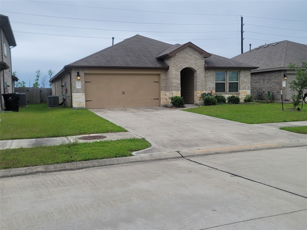 846 Autumn Flats Way Rosharon, TX 77583 - Photo 3 of 26 a front view of a house with a yard and garage