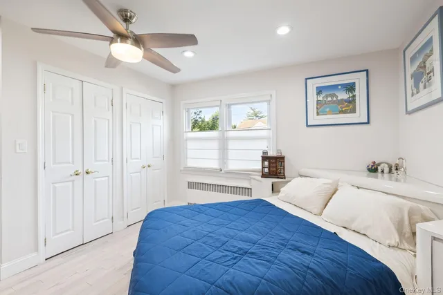 a bedroom with a large bed and a window