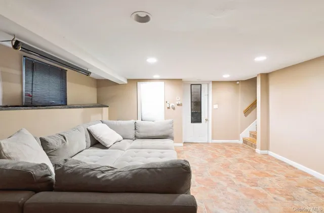 a dining room with furniture and a window
