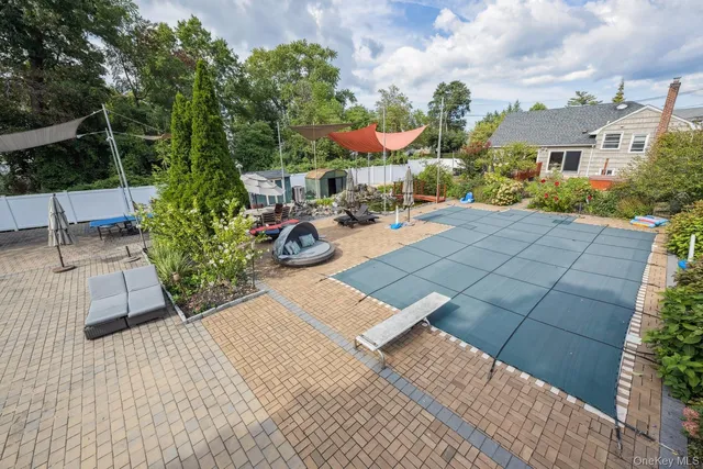 a view of swimming pool with sitting area