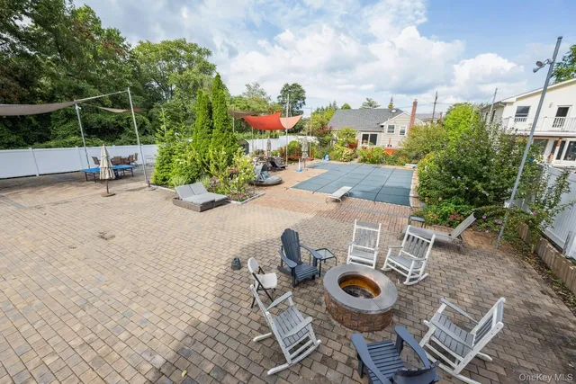 a view of a patio with table and chairs and potted plants