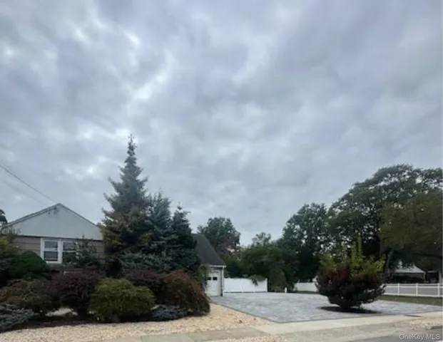 a view of a house with a yard and hanging chair