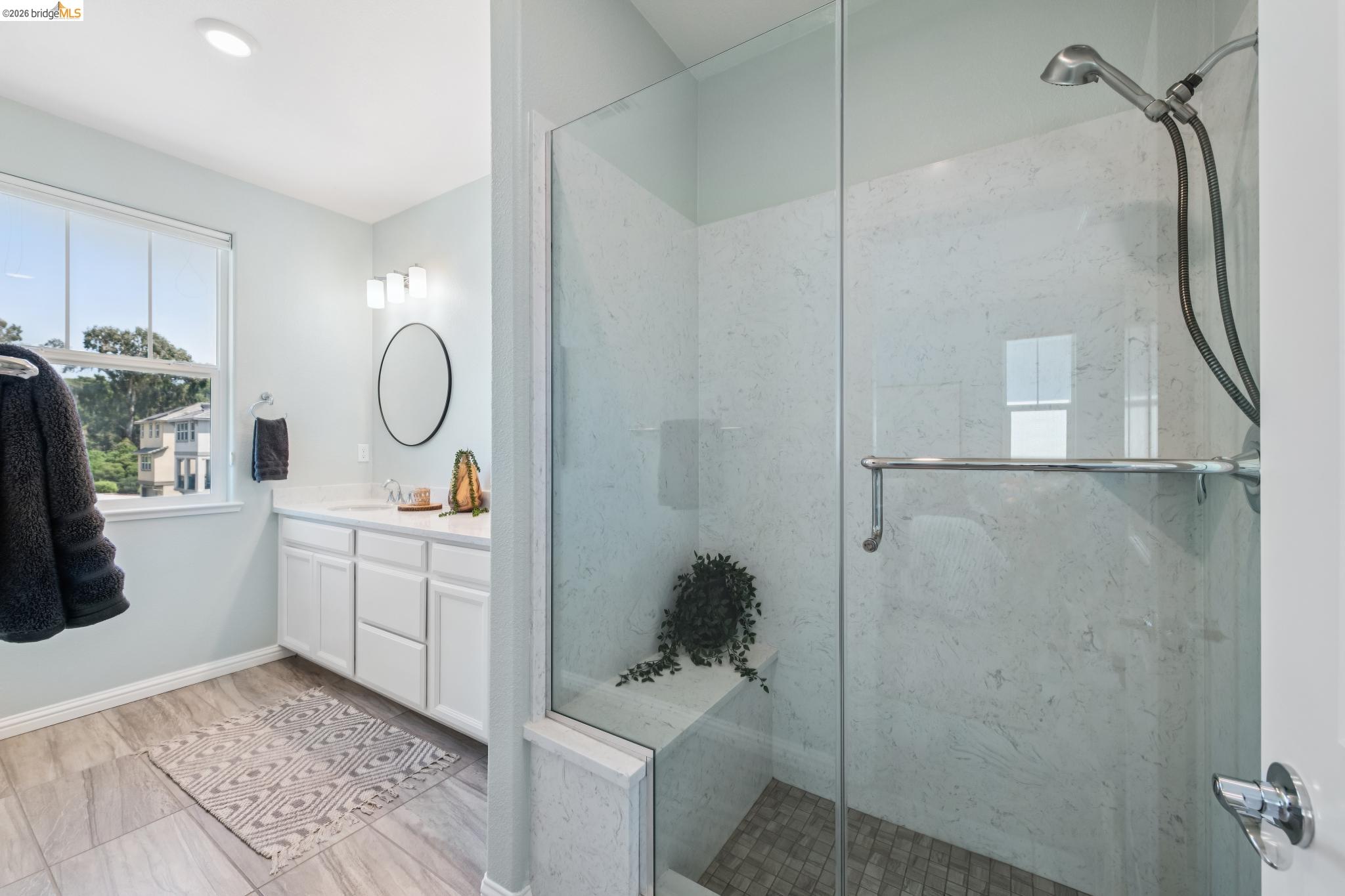 24157 Amaranth Loop Hayward, CA 94541 - Photo 38 of 63 Modern bathroom featuring a glass-enclosed shower with a built-in bench and handheld showerhead
