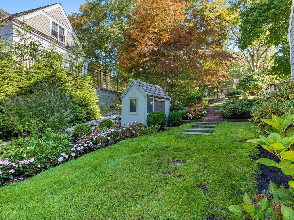 62 Arnold Road Wellesley, MA 02481 - Photo 22 of 24 a front view of a house with garden