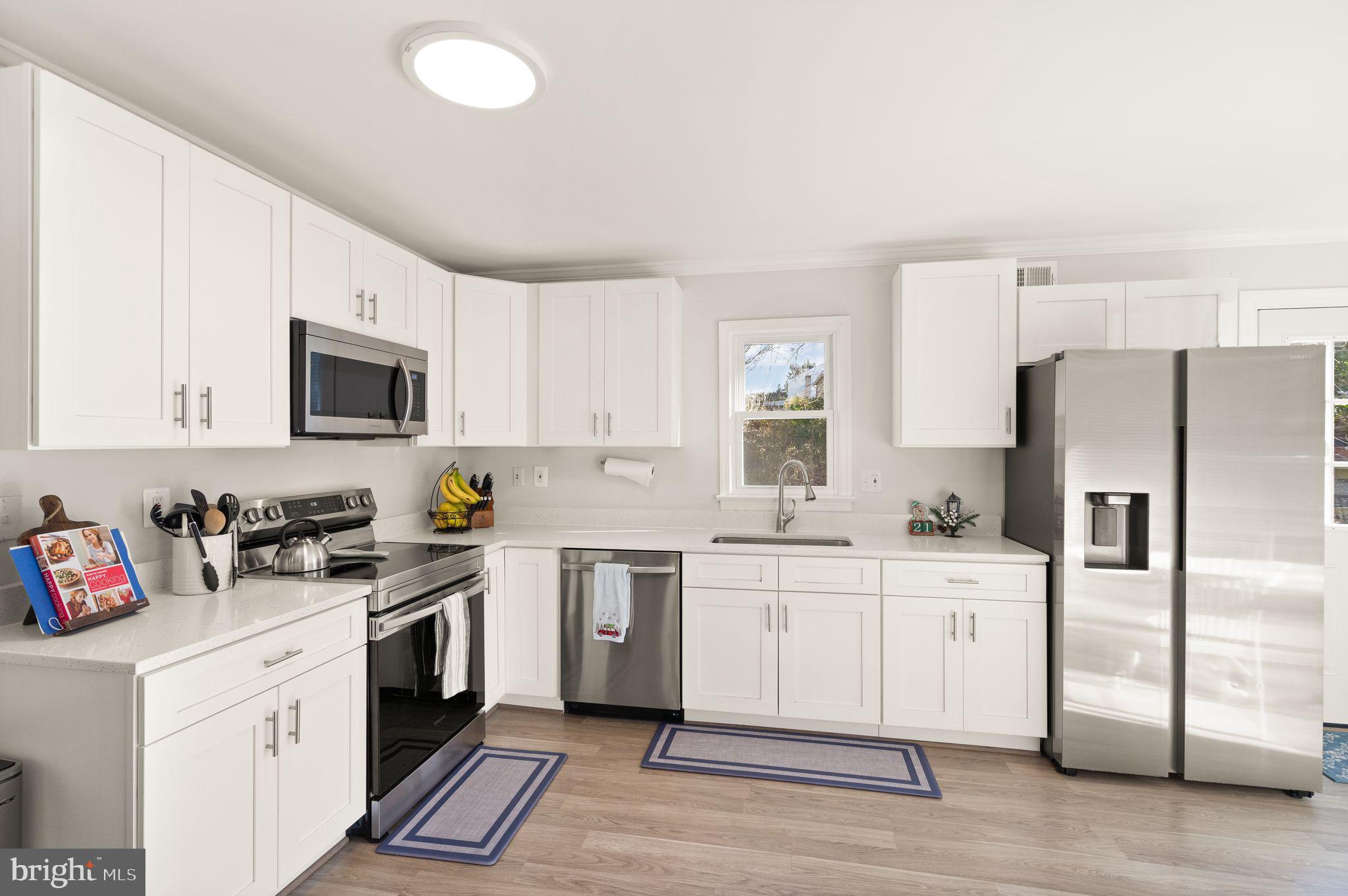 10808 Hunt Club Road Reston, VA 20190 - Photo 13 of 49 a kitchen with a sink stove and refrigerator