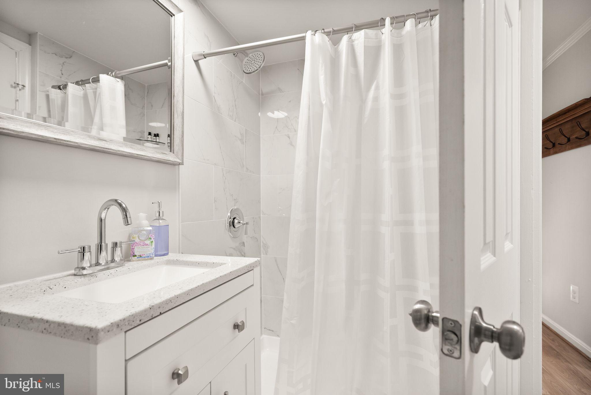 10808 Hunt Club Road Reston, VA 20190 - Photo 22 of 49 a bathroom with a sink vanity and a mirror