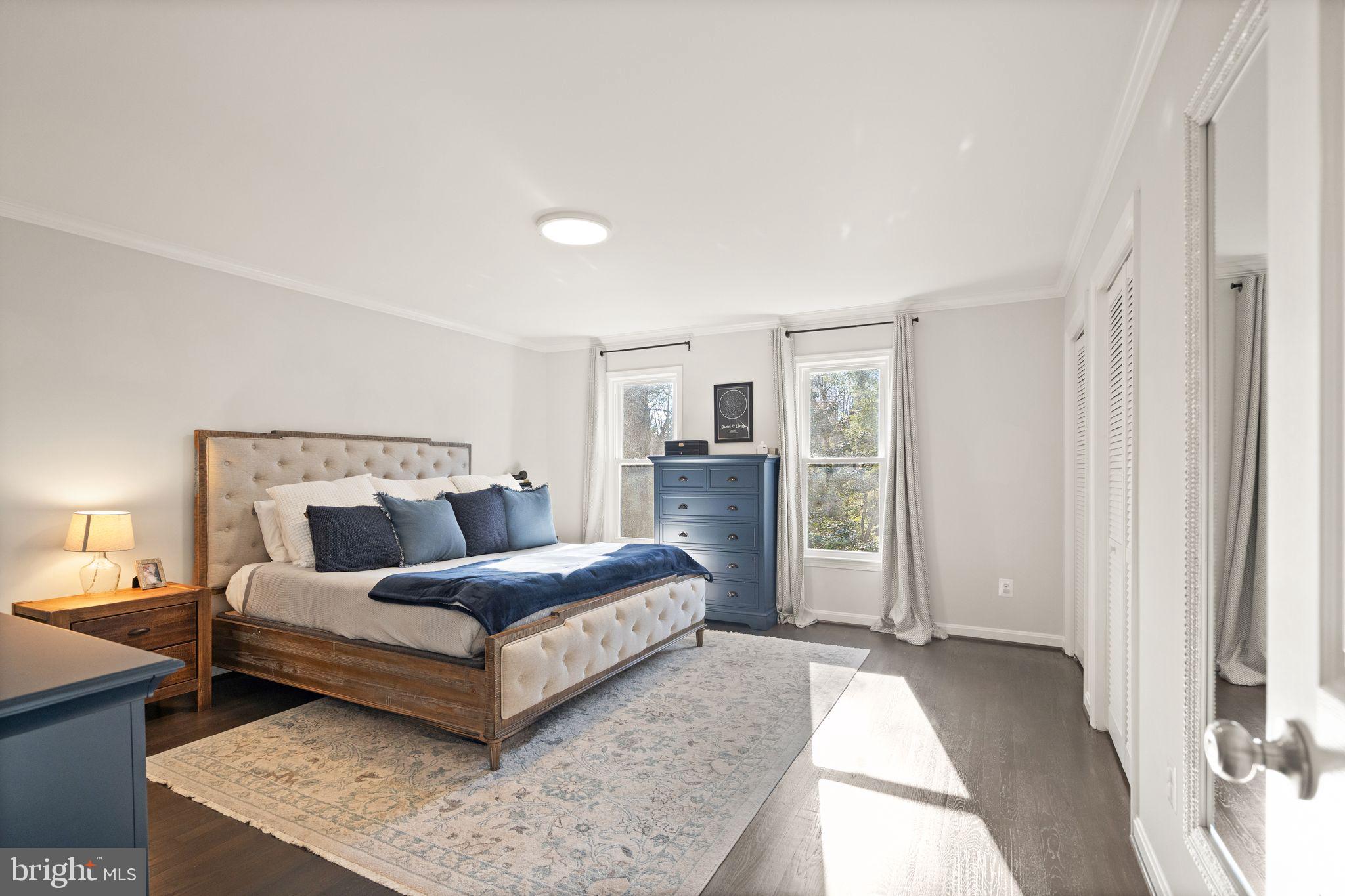 10808 Hunt Club Road Reston, VA 20190 - Photo 25 of 49 a bedroom with a large bed and a couch