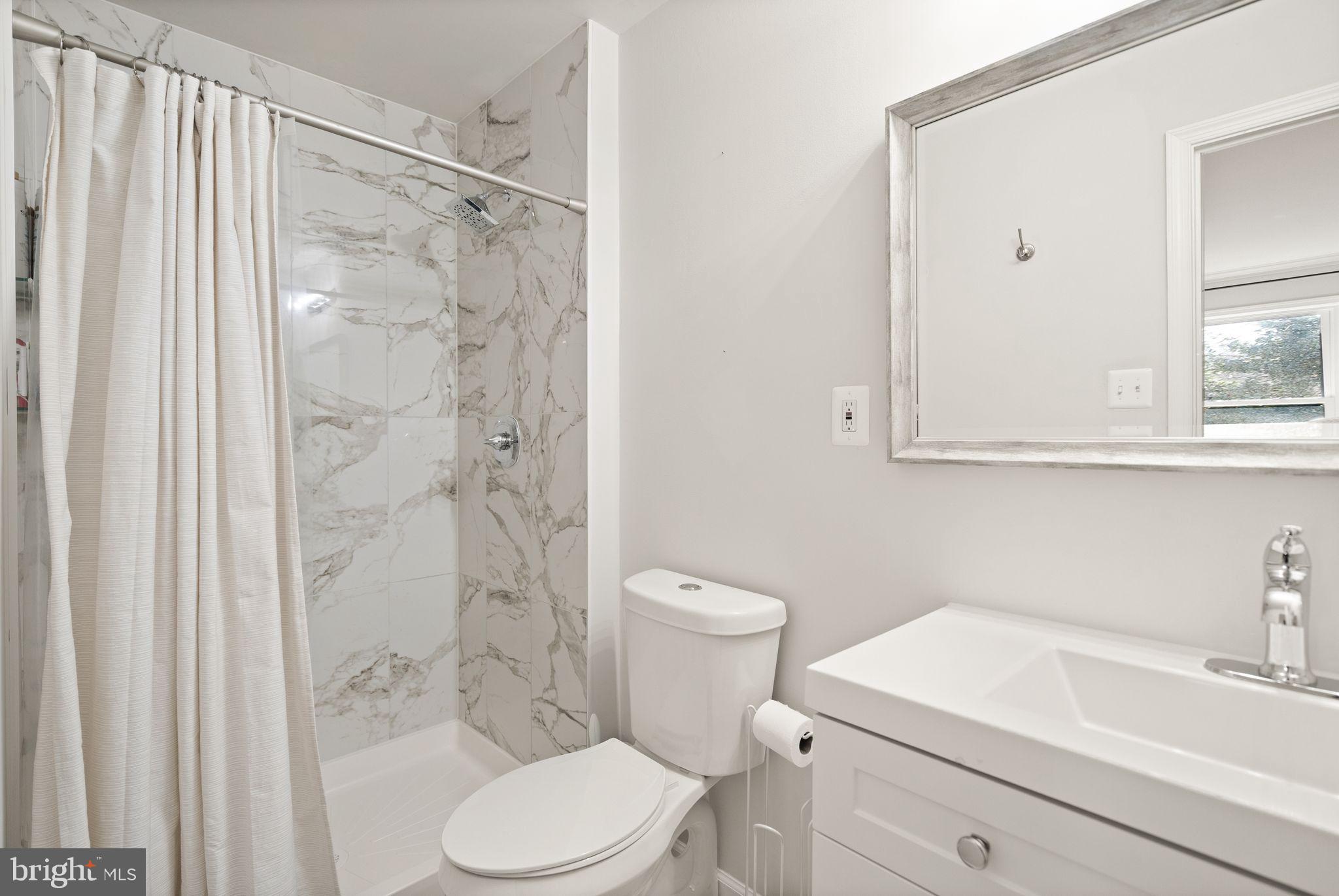 10808 Hunt Club Road Reston, VA 20190 - Photo 26 of 49 a bathroom with a sink a toilet and shower