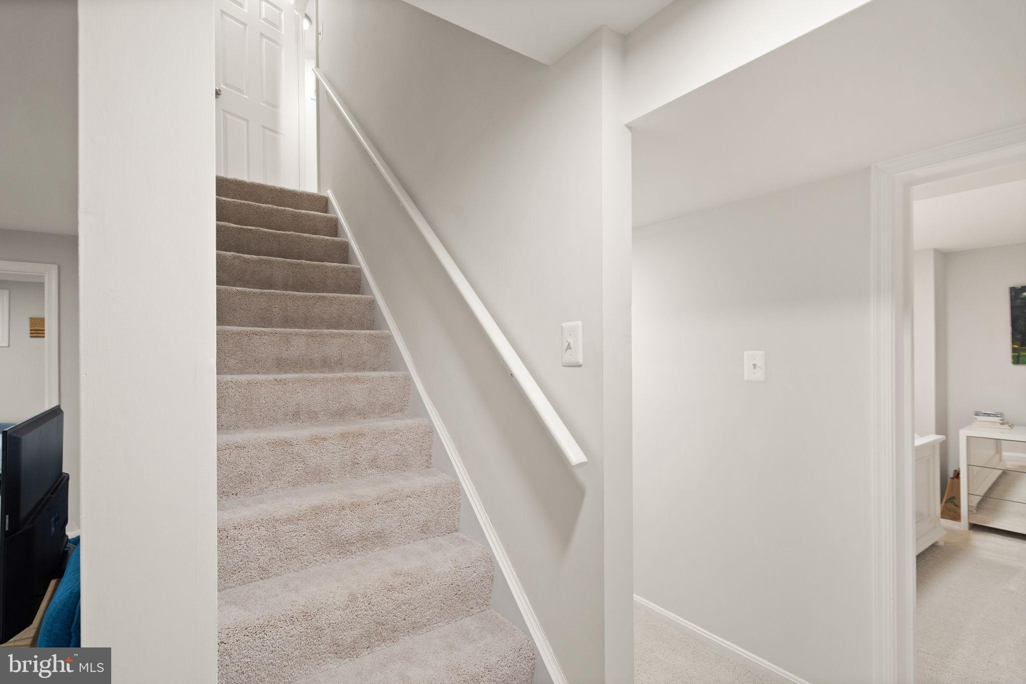 10808 Hunt Club Road Reston, VA 20190 - Photo 36 of 49 a view of staircase with white walls and a window
