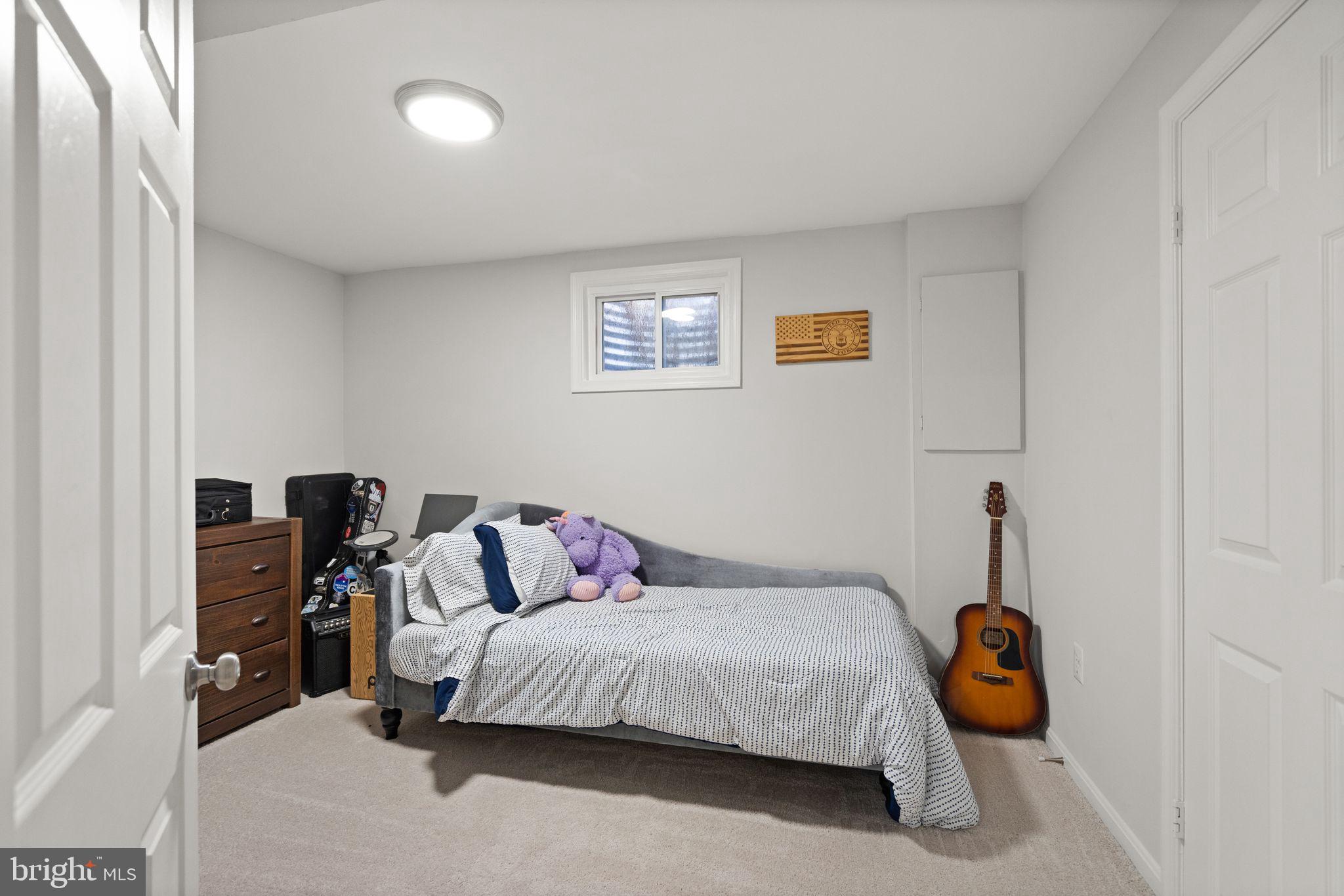 10808 Hunt Club Road Reston, VA 20190 - Photo 41 of 49 a bedroom with a bed and a window