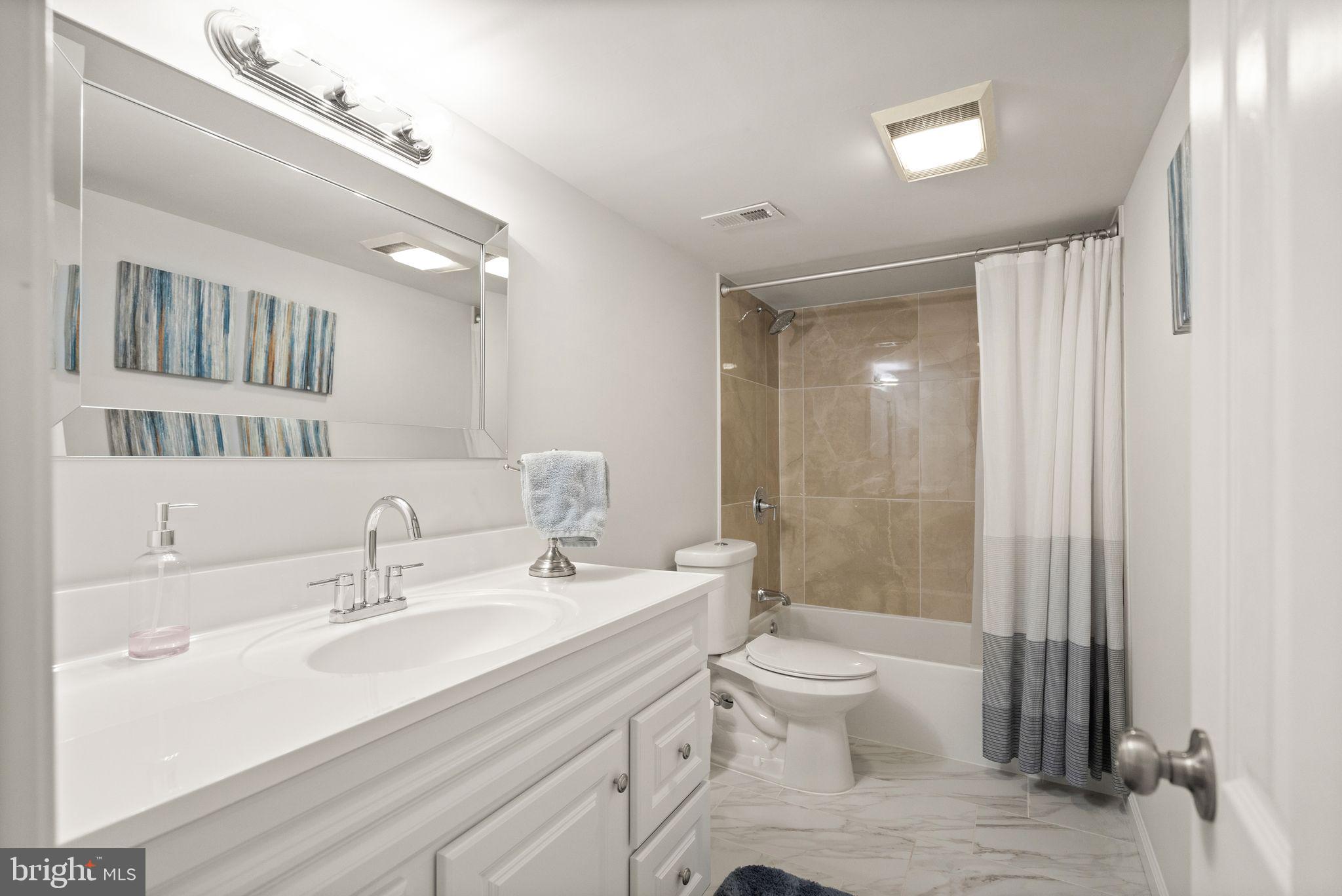 10808 Hunt Club Road Reston, VA 20190 - Photo 42 of 49 a bathroom with a double vanity sink toilet and shower