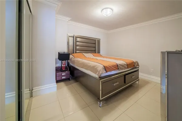 a bed sitting in a room next to a window