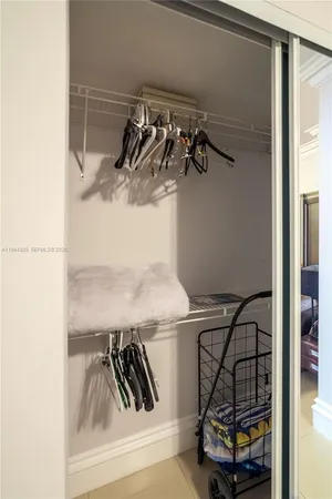 a bedroom with bed and a mirror