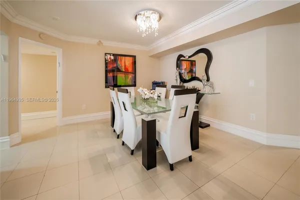 a dining room with furniture and a chandelier