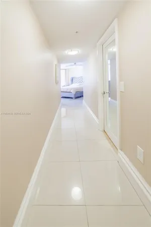 a large bed sitting in a bedroom next to a window