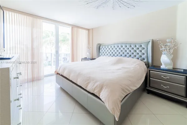 a bedroom with a bed and flat screen tv