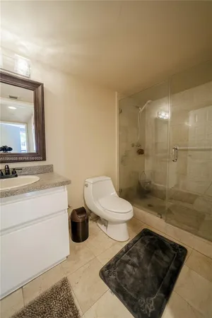 a bathroom with a toilet a sink and shower