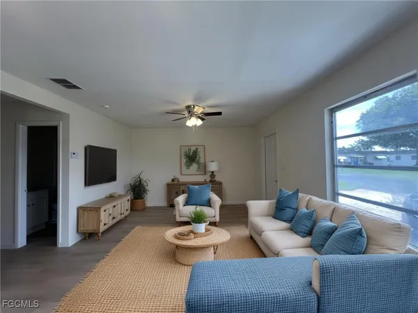 a living room with furniture and a flat screen tv