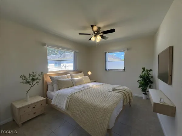 a bedroom with bed and a chandelier