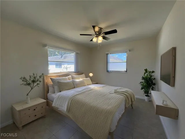 a bedroom with bed and a chandelier